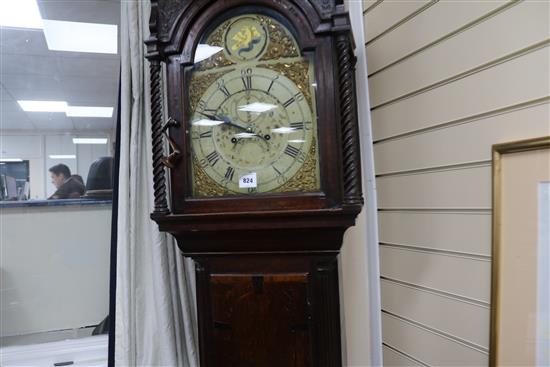 A late 18th century oak and mahogany eight day longcase clock, with painted arched and gilt brass dial